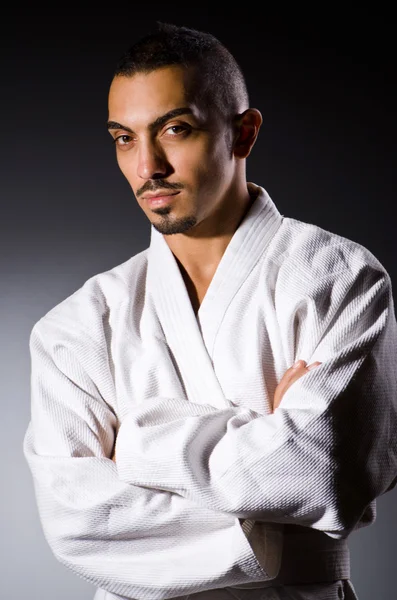 Karate player in dark room — Stock Photo, Image