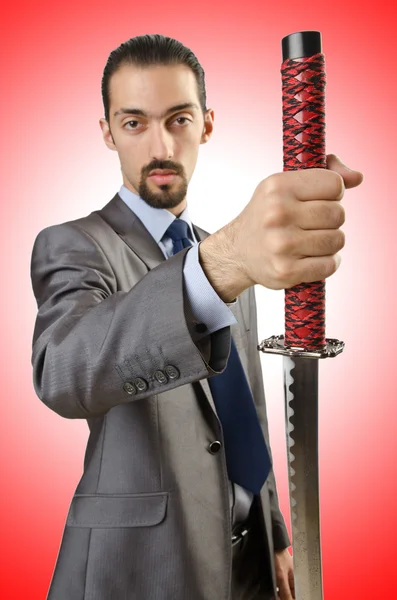 Businessman with sword against the gradient — Stock Photo, Image