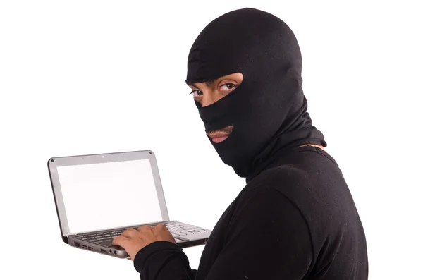 Hacker with computer wearing balaclava — Stock Photo, Image