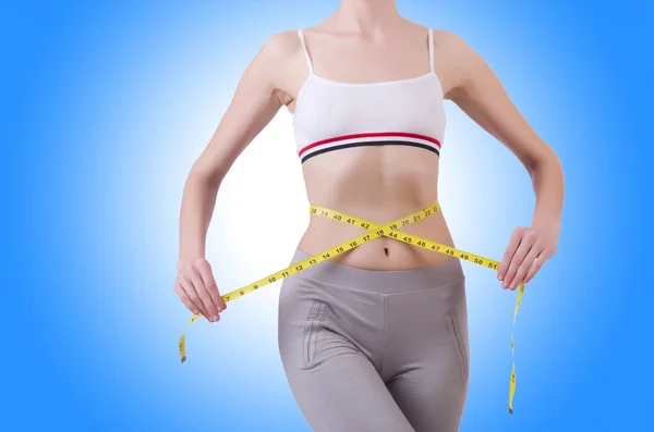 Young girl with centimeter in dieting concept — Stock Photo, Image