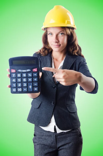 Female builder with calculator against the gradient — Stock Photo, Image