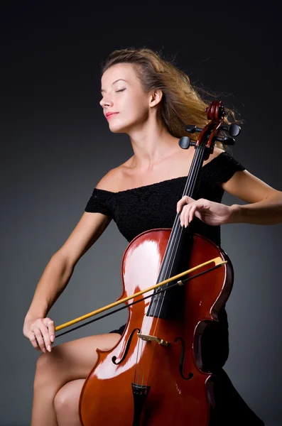 Female musical player against grey background — Stock Photo, Image