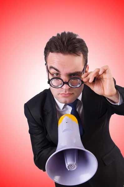 Young businessman with loudspeaker against the gradient — Stock Photo, Image