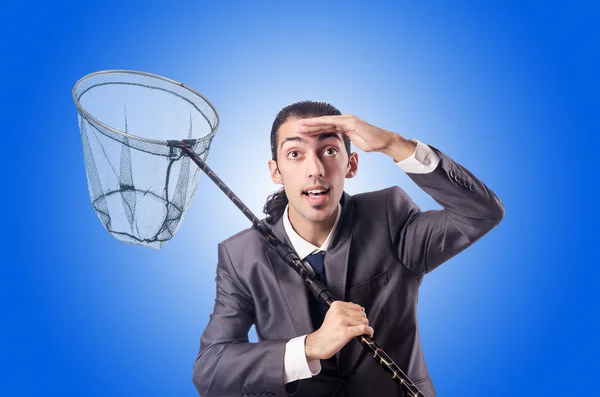 Businessman with net against the gradient — Stock Photo, Image