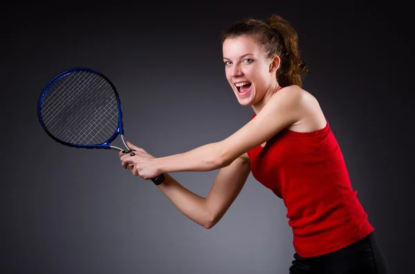 Woman tennis player against dark background — Stock Photo, Image