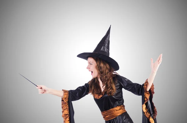 Witch with wand against the gradient — Stock Photo, Image