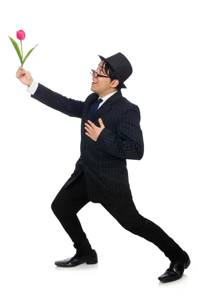 Jonge man in zwart kostuum met bloem geïsoleerd op wit — Stockfoto