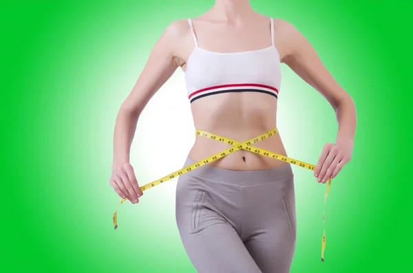 Young girl with centimeter in dieting concept — Stock Photo, Image