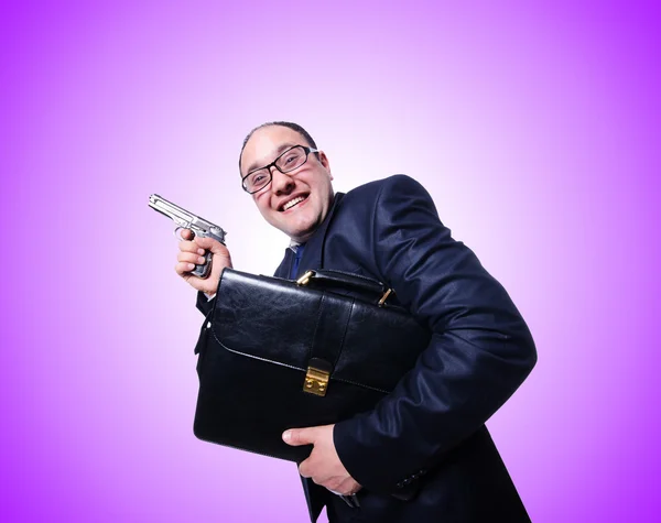 Businessman with gun against the gradient — Stock Photo, Image