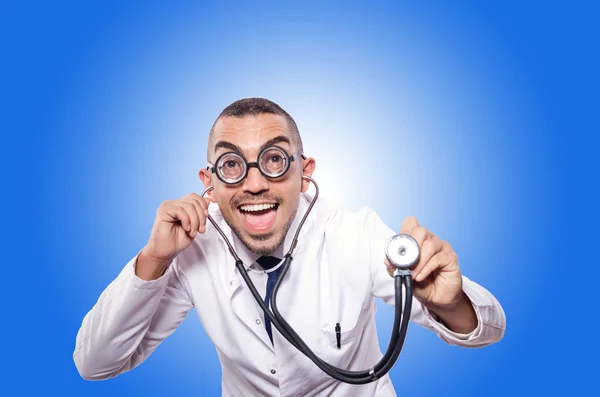 Funny doctor with skeleton against the gradient — Stock Photo, Image