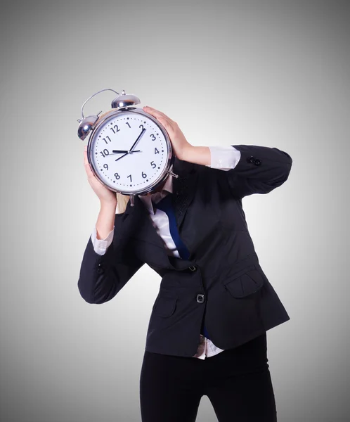 Woman with giant clock against the gradient Royalty Free Stock Images