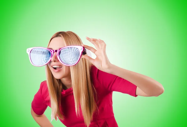 Tall model with giant sunglasses against the gradient — Stock Photo, Image