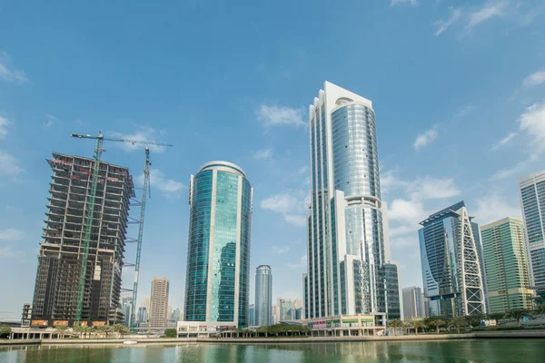 Tall skyscrapers in Dubai near water — Stock Photo, Image