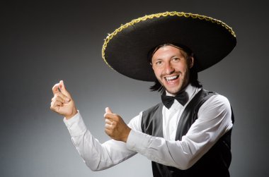 Mexican man wears sombrero against the gradient