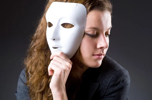 Woman with mask in hypocrisy concept — Stock Photo, Image