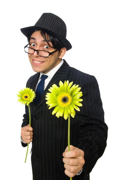Junger Mann im schwarzen Kostüm mit Blume auf weißem Hintergrund — Stockfoto