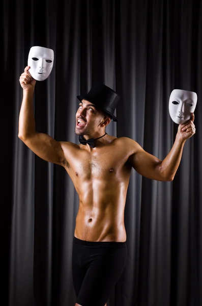 Muscular actor with theatrical masks — Stock Photo, Image