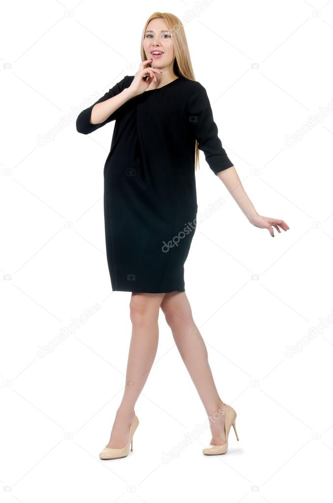 Pretty pregnant woman in mini black dress isolated on white