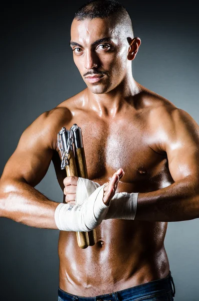 Man with nunchucks — Stock Photo, Image