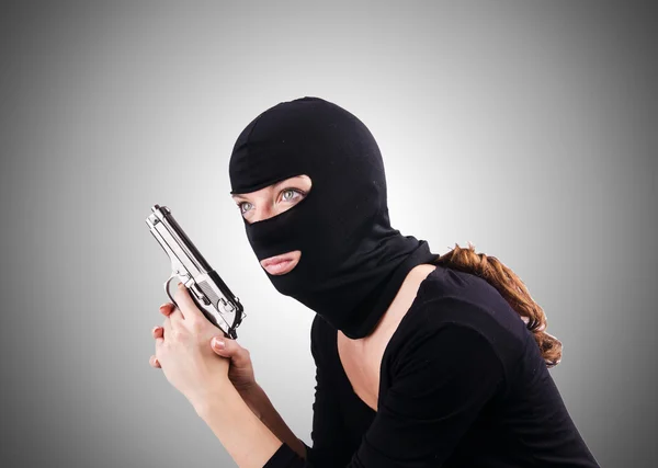 Criminal with gun against the gradient — Stock Photo, Image