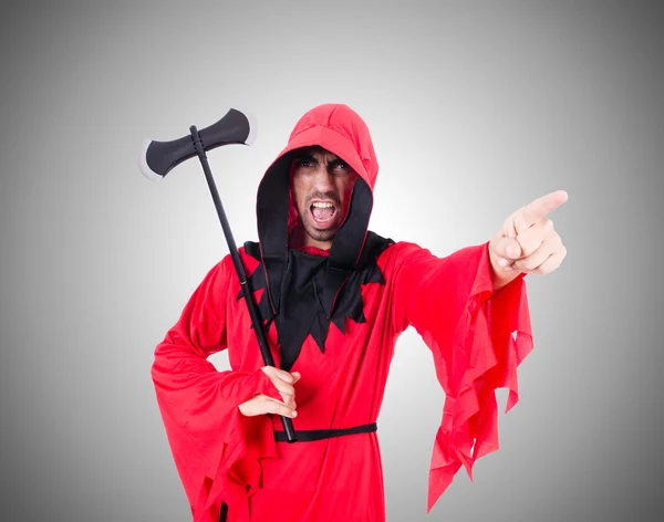 Executioner in red costume with axe against the gradient — Stock Photo, Image