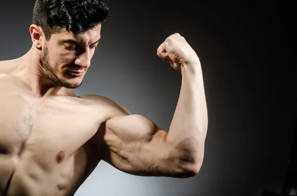 Muscular man posing on grey background — Stock Photo, Image