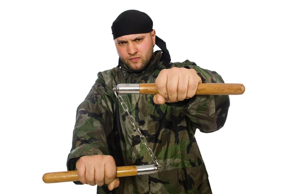 Jeune homme en uniforme de soldat tenant des nunchaks isolés sur blanc — Photo