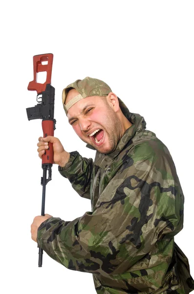 Young man in soldier uniform holding gun isolated on white — Stock Photo, Image