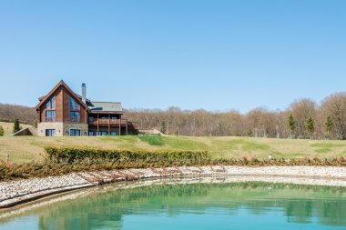 Parlak gün su yakınında modern ev