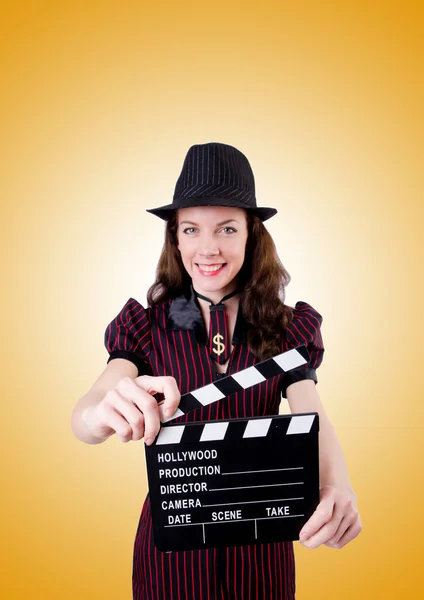 Woman gangster with movie board against the gradient — Stock Photo, Image