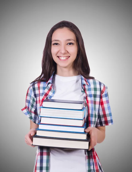 Menina estudante com muitos livros contra o gradiente — Fotografia de Stock