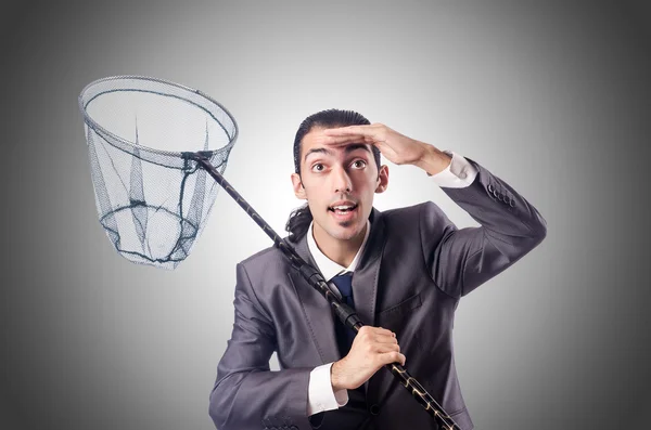 Businessman with net against the gradient — Stock Photo, Image
