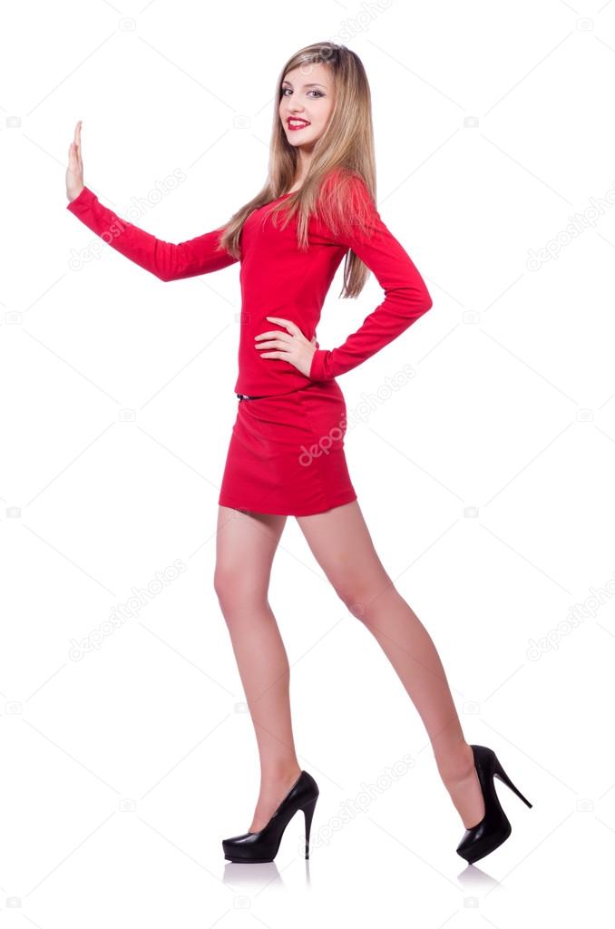Young blonde girl in red short  dress pushing isolated on white