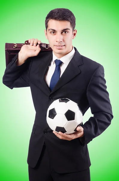 Young businessman with ball against the gradient — Stock Photo, Image