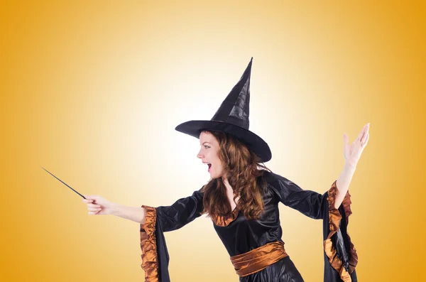 Witch with wand against the gradient — Stock Photo, Image