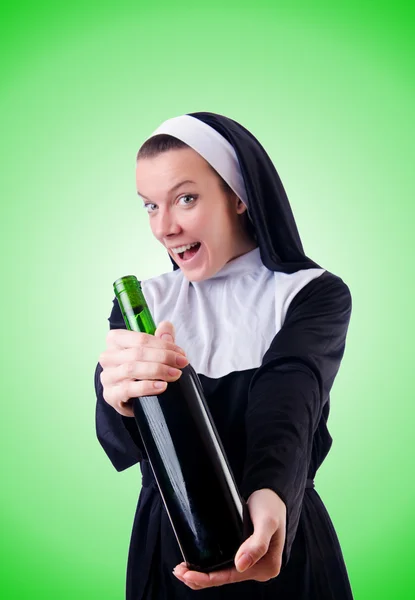 Nun with bottle of red wine — Stock Photo, Image