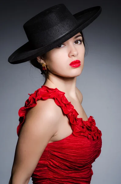 Woman wearing hat against dark background — Stock Photo, Image