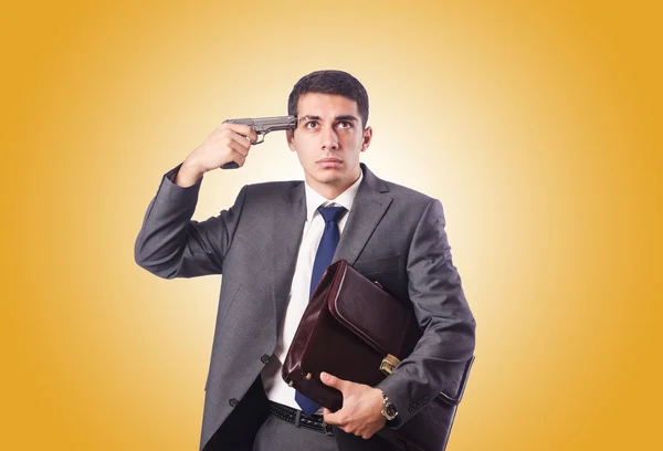 Businessman thinking of suicide against gradient — Stock Photo, Image