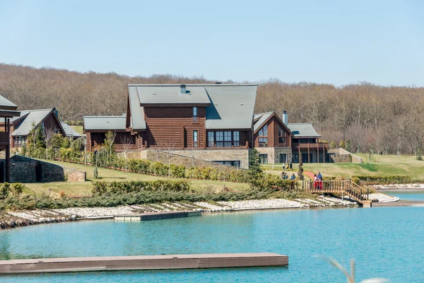 Modern house near water on bright day — Stock Photo, Image