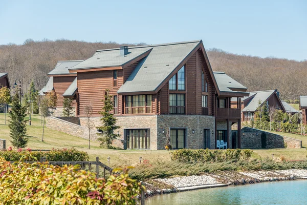 Modern house near water on bright day — Stock Photo, Image