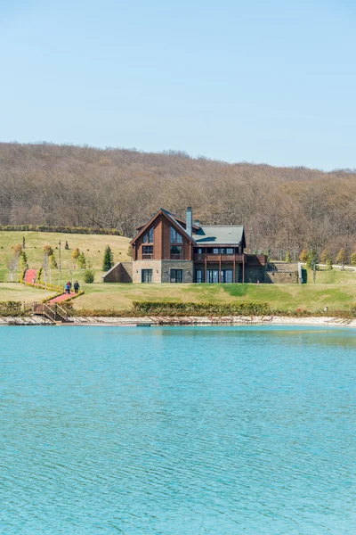 Modern house near water on bright day — Stock Photo, Image