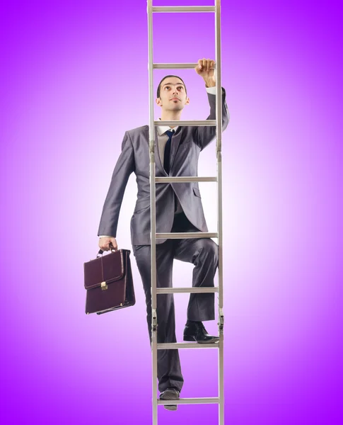 Businessman climbing the ladder against the gradient — Stock Photo, Image