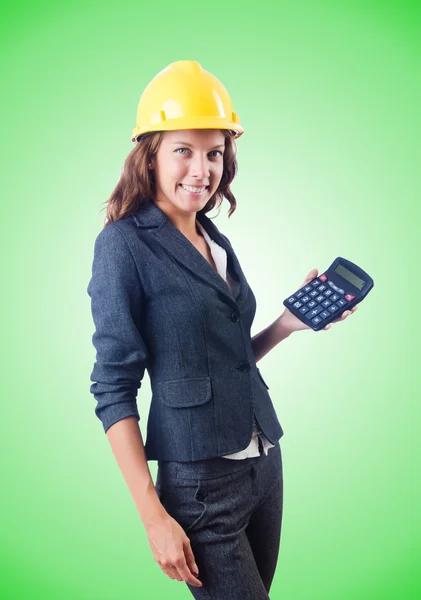 Female builder with calculator against the gradient — Stock Photo, Image