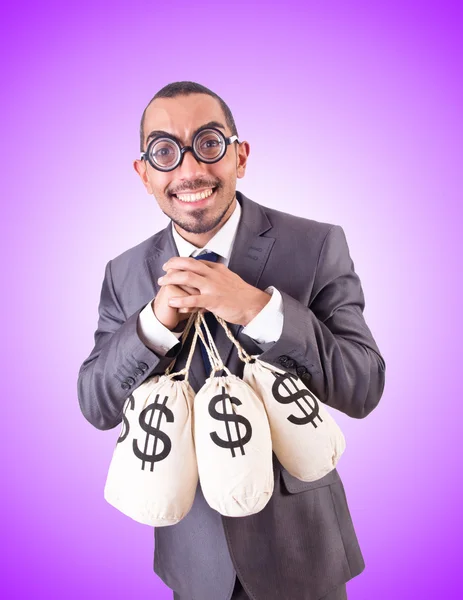 Man with sacks of money against the gradient — Stock Photo, Image