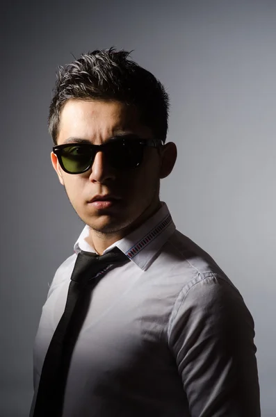 Young man in cool sunglasses isolated on gray — Stock Photo, Image