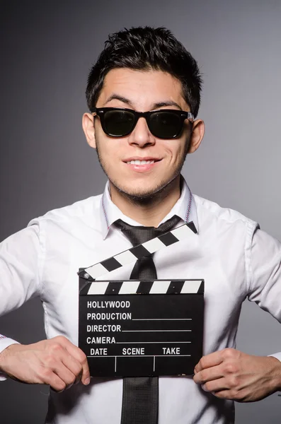 Young man in cool sunglasses holding chalkboard isolated on gray — Stock Photo, Image