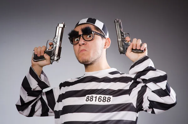 Engraçado prisioneiro com arma isolada em cinza — Fotografia de Stock