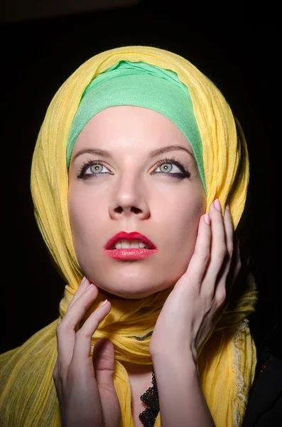 Serious woman wearing colourful headscarf — Stock Photo, Image