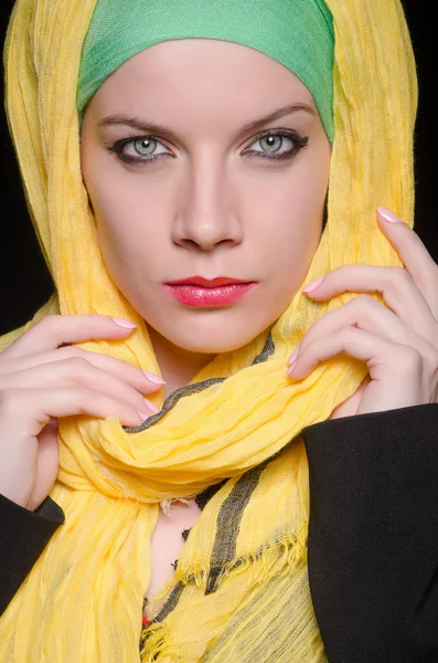 Serious woman wearing colourful headscarf Royalty Free Stock Images