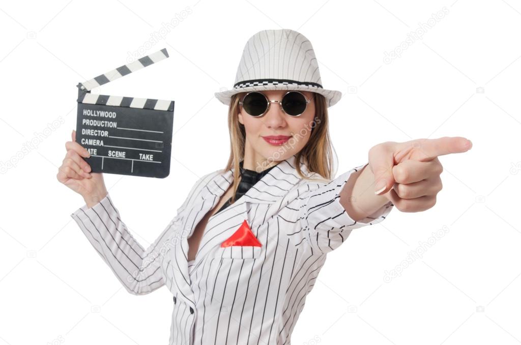 Beautiful girl in striped clothing holding clapperboard isolated